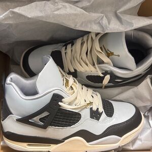 Jordan 4 Sneakers in light blue, Black, cream, and Gold